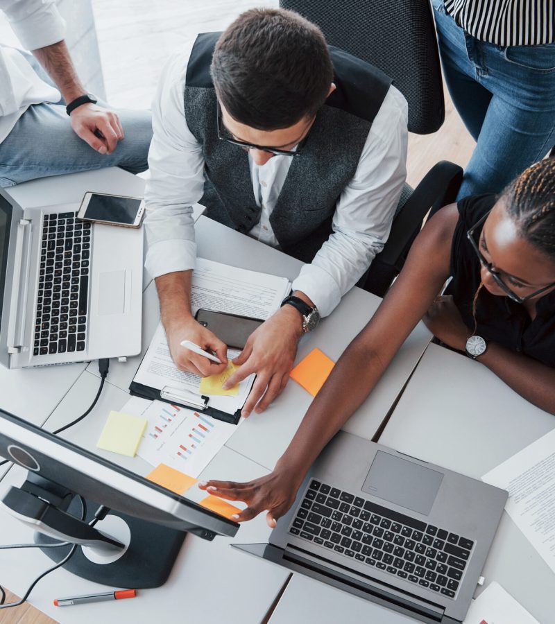 A group of multinational busy people working in the office. Height view
